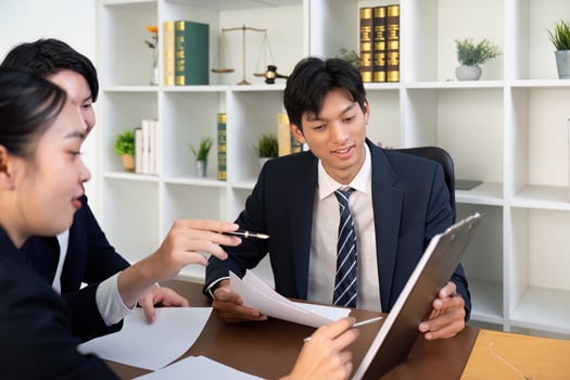 Focused Legal Professionals Reviewing Important Documents in Office photo