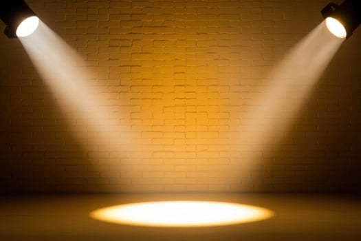 Stage lights illuminating a brick wall photo