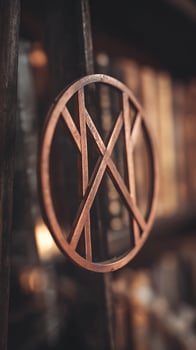 Ancient Ornate Metal Design Hanging with Soft Bokeh Background. photo