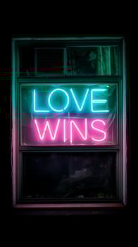 Bright Neon Love Wins Sign Glowing in a Dark Window. photo