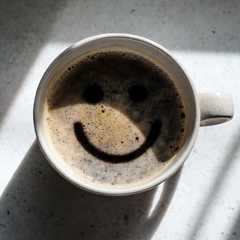 Cup of Coffee with a Happy Face Design on Top. photo
