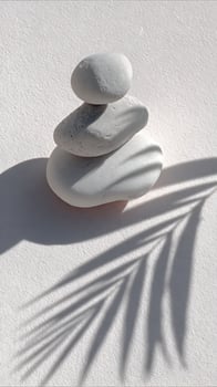 Peaceful Stacked Stones with Gentle Palm Leaf Shadow. photo