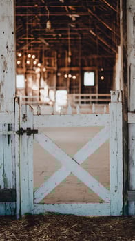 Rustic Barn Gate Opens to Warm, Inviting Farm Interior Lights photo