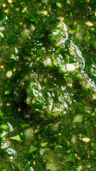 Vivid Green Herb Sauce Close Up Texture with Diced Ingredients. photo
