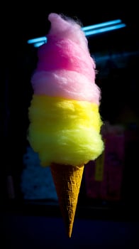 Brightly Colored Cotton Candy Cone Sweet Treat on Dark Background. photo