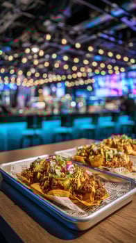 Delicious Loaded Nachos on a Metal Tray in a Lively Bar Setting. photo