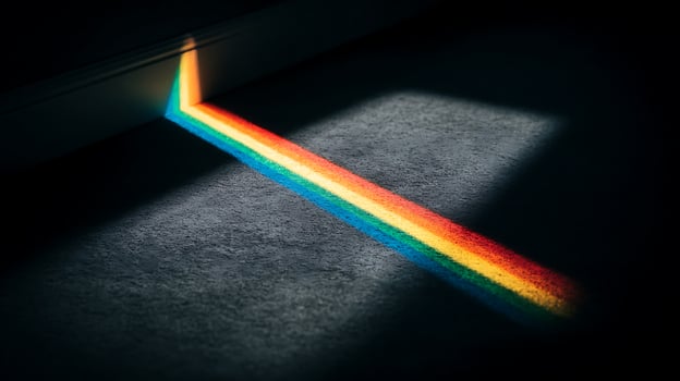 A spectrum of light stripes across a textured dark surface. photo