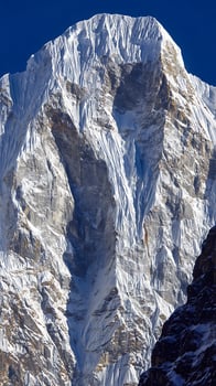 Majestic Snow Covered Mountain Peaks Under A Clear Blue Sky. photo