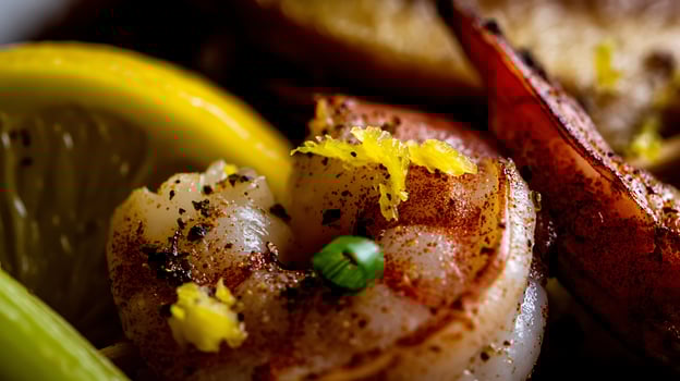 Delicious Shrimp Skewers with Lemon and Spices Close Up. photo