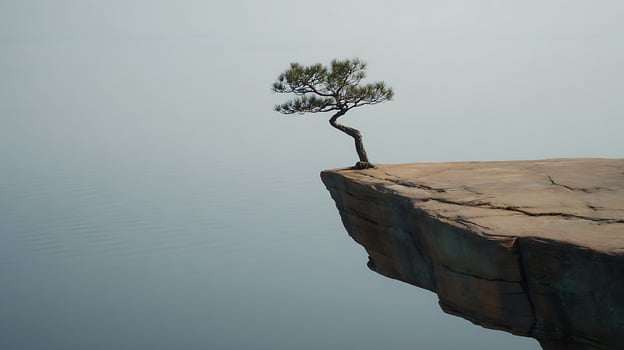 Solitary Tree Stands Firmly on a Dramatic Cliff Edge Over Water. photo
