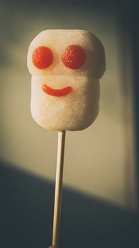 Adorable Marshmallow Treat With A Happy Face On A Stick. photo