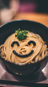A Bowl of Noodles with a Happy Face Design. photo
