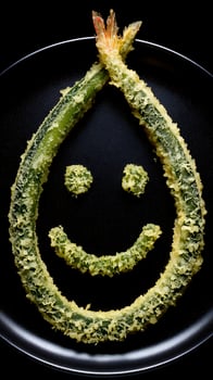 Happy Chef Creates Delicious Emoji Face with Shrimp and Greens. photo