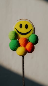 Happy Face Candy Flower on a Stick with Sparkle. photo