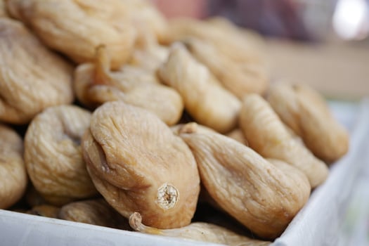 Dried figs piled in a market for sale photo