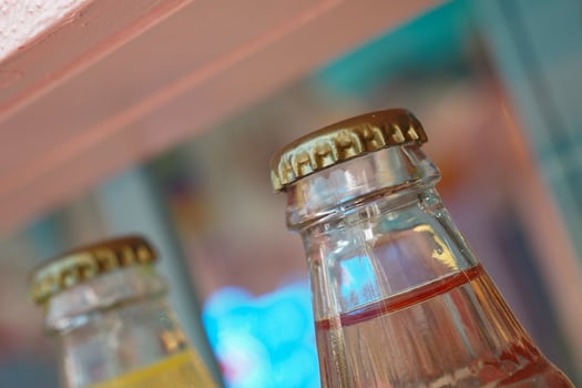 Soft drink bottles with colorful backdrop in a store photo