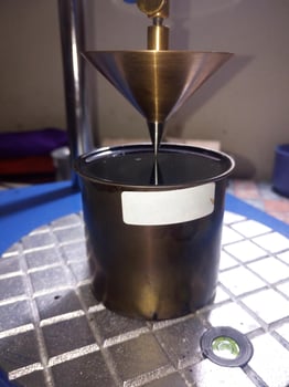 Close up photo of Cone penetration test on asphalt to measure the resilience of asphalt mixtures with additives.