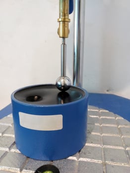 Ball penetration test on asphalt to measure the resilience of bitumen mixtures. photo