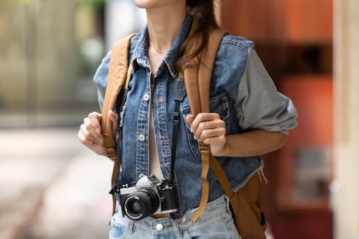 Adventurous Young Woman with Backpack and Camera photo