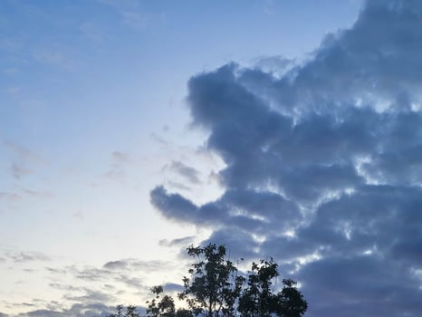 Strange evening storm clouds in the sky at sunset photo