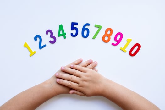 Child hands with colorful numbers on white background photo