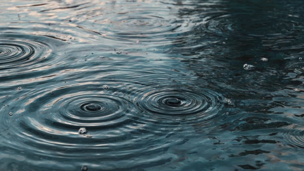 Calm Rainwater Ripples on a Tranquil Surface Reflecting Soft Light from a Dusk Sky Over a Peaceful Waterbody photo