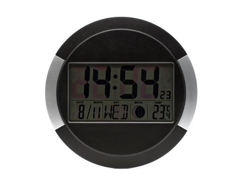 A modern round digital clock displays the current time, date, day of the week, moon phase, and indoor temperature against a clean white background. photo