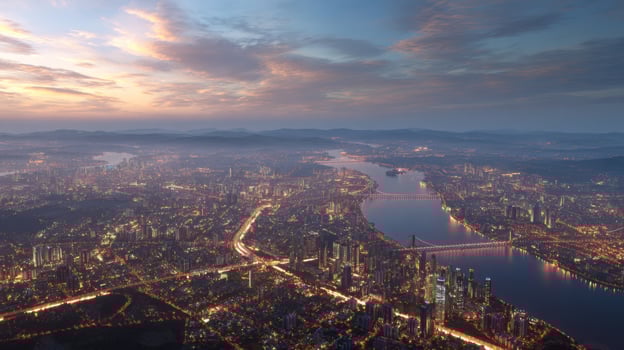 Breathtaking Aerial View of a Vibrant Cityscape at Dusk with Illuminated Buildings and Serene River Reflection photo