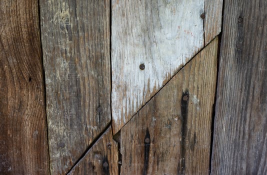 Weathered wooden planks with a diagonal line, a great textural background. photo