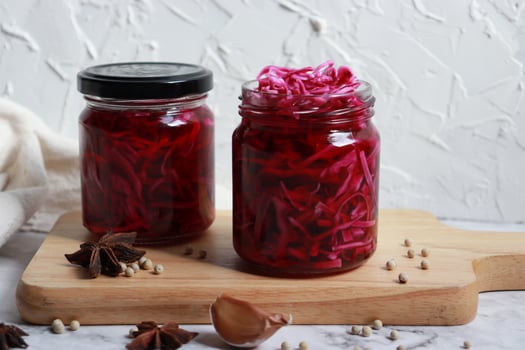 Pickled purple cabbage in glass bottles. Probiotics food. photo