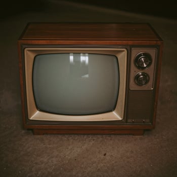 Retro-style TV mockup featuring a blank screen and classic display backdrop photo