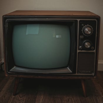 Retro-style television with a blank, dark screen mockup, vintage TV background scene photo