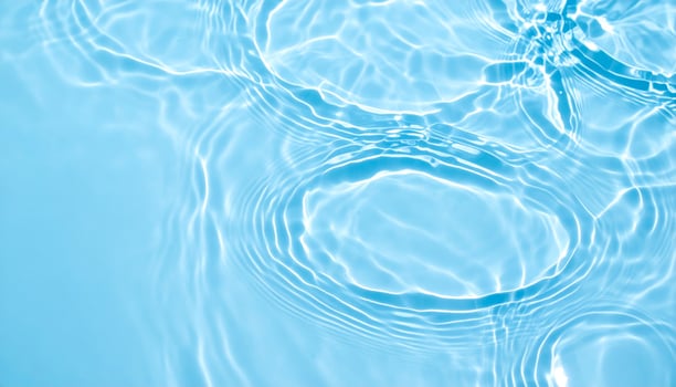 Background of shimmering, rippling light blue water photo