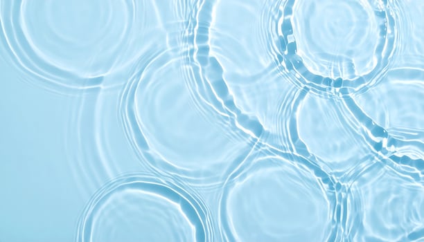Soft blue water with gentle ripples and waves in the background photo