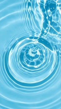 A serene scene of pale blue water shimmering with gentle ripples and waves photo