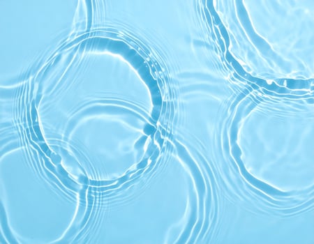 A tranquil blue body of water with gentle ripples and waves as the backdrop photo