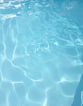 Background of pale blue waters with gentle ripples and waves photo