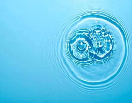 Background of shimmering, ripple-filled pale blue water photo