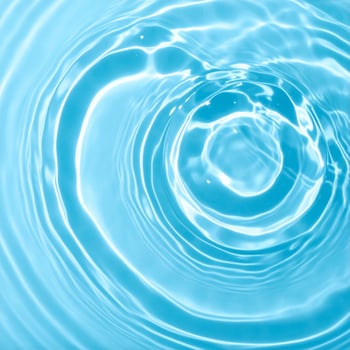 Background of rippling, light blue water waves photo