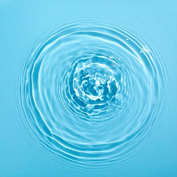 Background of shimmering pale blue water with gentle ripples and waves photo