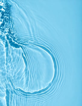 Background of turquoise water with gentle ripples and rolling waves photo