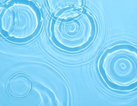 A tranquil splash of pale blue water with gentle ripples and waves photo
