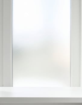 Close-up of frosted matte glass with a soft, out-of-focus backdrop photo