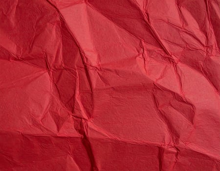 Close-up of deep crimson paper surface with a textured pattern, ideal for presentation backgrounds photo