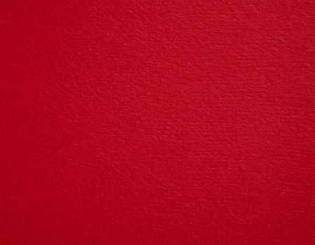 Close-up of deep red textured paper background, ideal for presentation themes photo