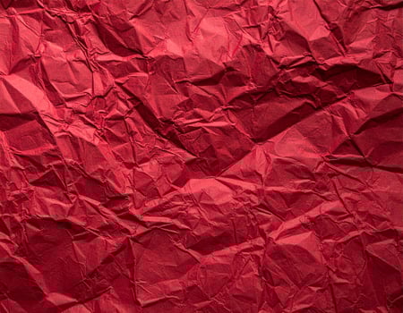 Close-up of a deep crimson paper surface with textured pattern for presentation backgrounds photo
