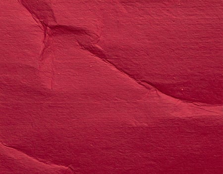 Close-up of deep-red textured paper background, ideal for presentation designs photo