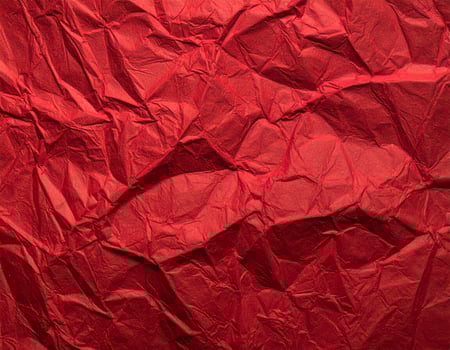 Close-up of deep crimson paper surface with textured pattern, ideal for presentation backgrounds photo