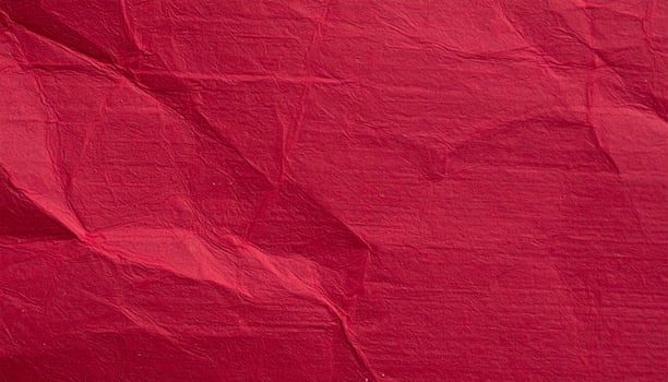 Close-up of a deep crimson paper surface, featuring a textured pattern for presentation backgrounds photo