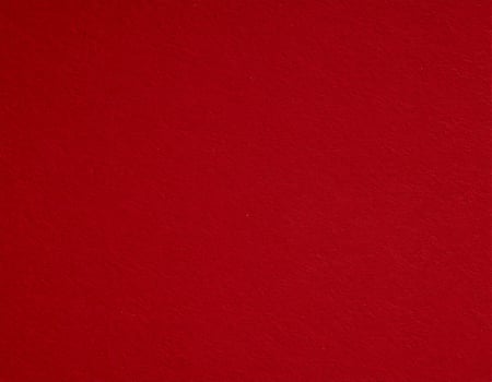 Close-up of deep crimson paper surface with textured red pattern, suitable for presentations. photo